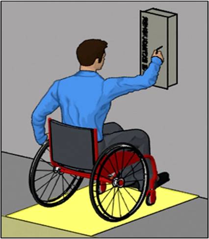 Person using wheelchair making forward approach to fire extinguisher cabinet