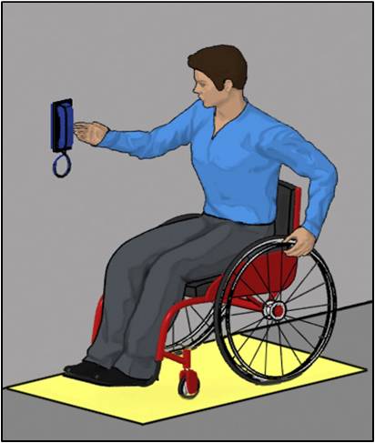 Person using wheelchair making side approach to wall-mounted phone