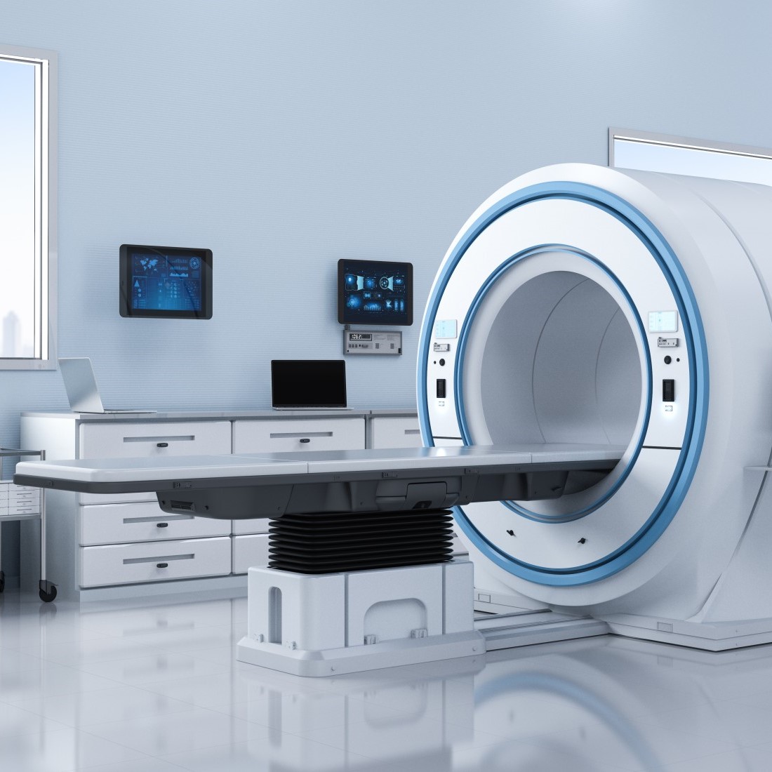 medical imaging machine (photo shows empty patient table at tunnel entrance of large device)