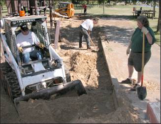 Figure 2---Removal of sand from existing playground surface.