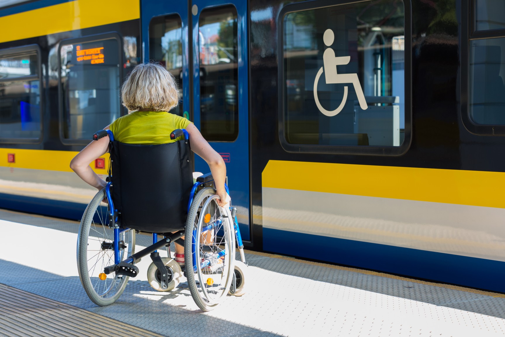 photo of  a wheelchair user boarding a bus