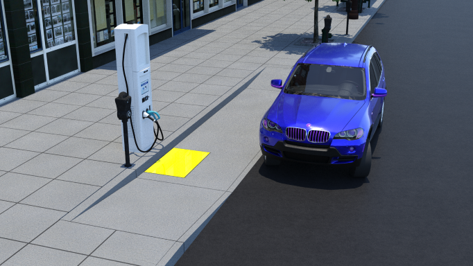A blue SUV is parked on the street parallel to a wide sidewalk with an access aisle in the sidewalk and that is flush with the vehicle space. Two parallel curb ramps provide access from the flush access aisle to the sidewalk. The EV charger is mounted on the curb parallel to the flush access aisle and at the head of the charging space. The yellow rectangle indicating the clear floor space is located on the access aisle at the face of the curb. The EV charger is offset slightly from the face of the curb. A parking meter is located beside the EV charger.
