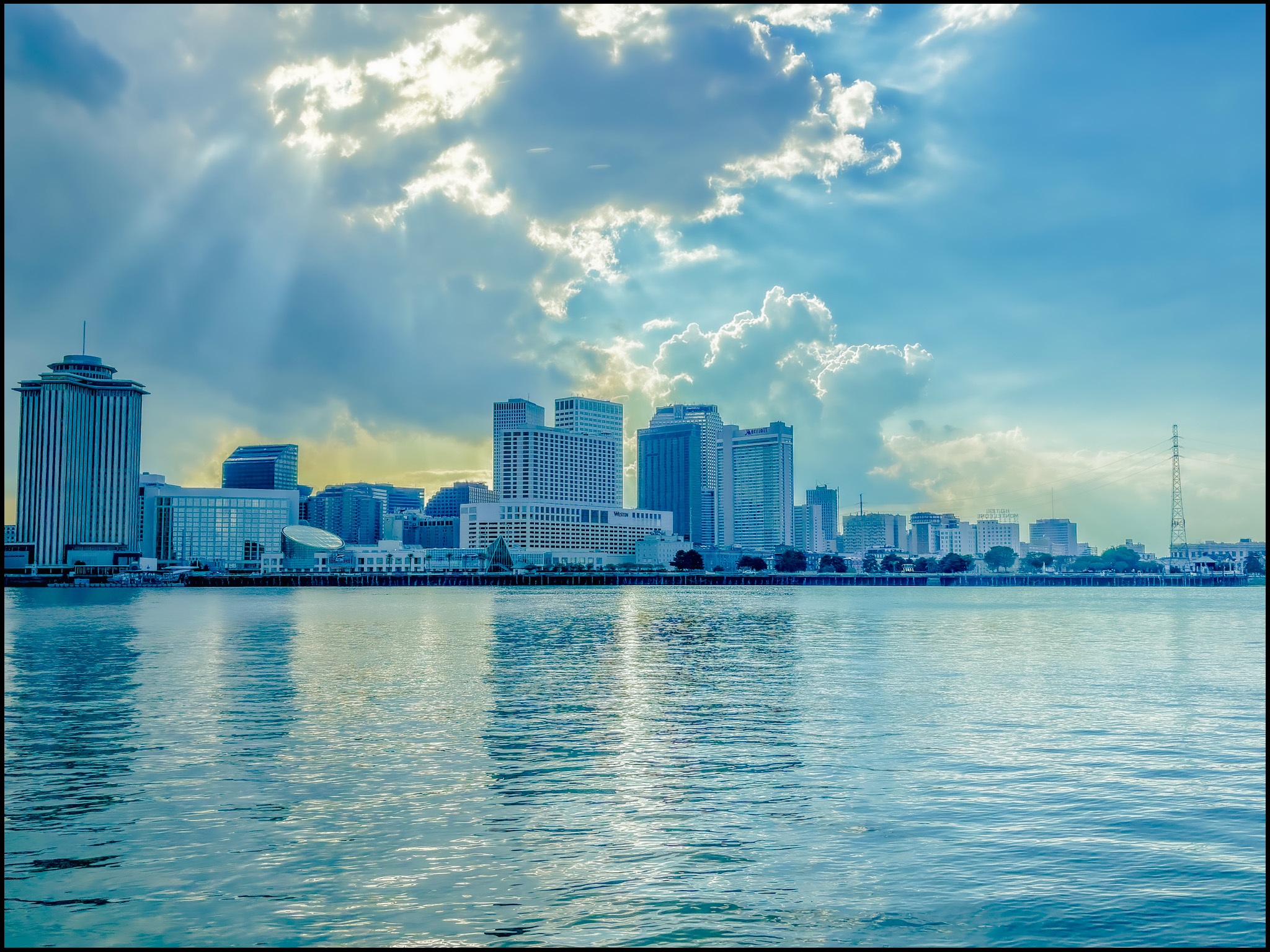 Skyline of New Orleans with light seeping through the clouds.